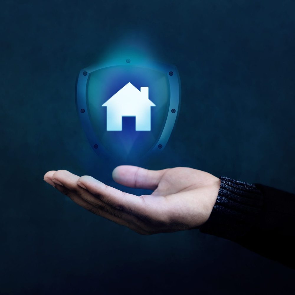 House or Family Insurance Concept. Company Supporting and Protecting their Customer by Shield, Home Icon floating over a Careful Gesture Hand of a Businessman